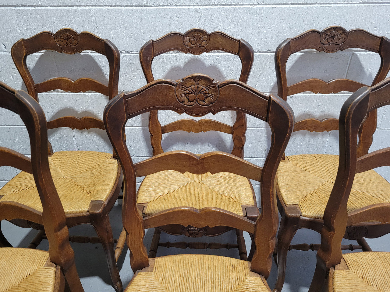 A stunning set of six French Louis XV Style oak dining chairs with rush seats in good original condition. All chairs have been detailed and re-glued where needed.
