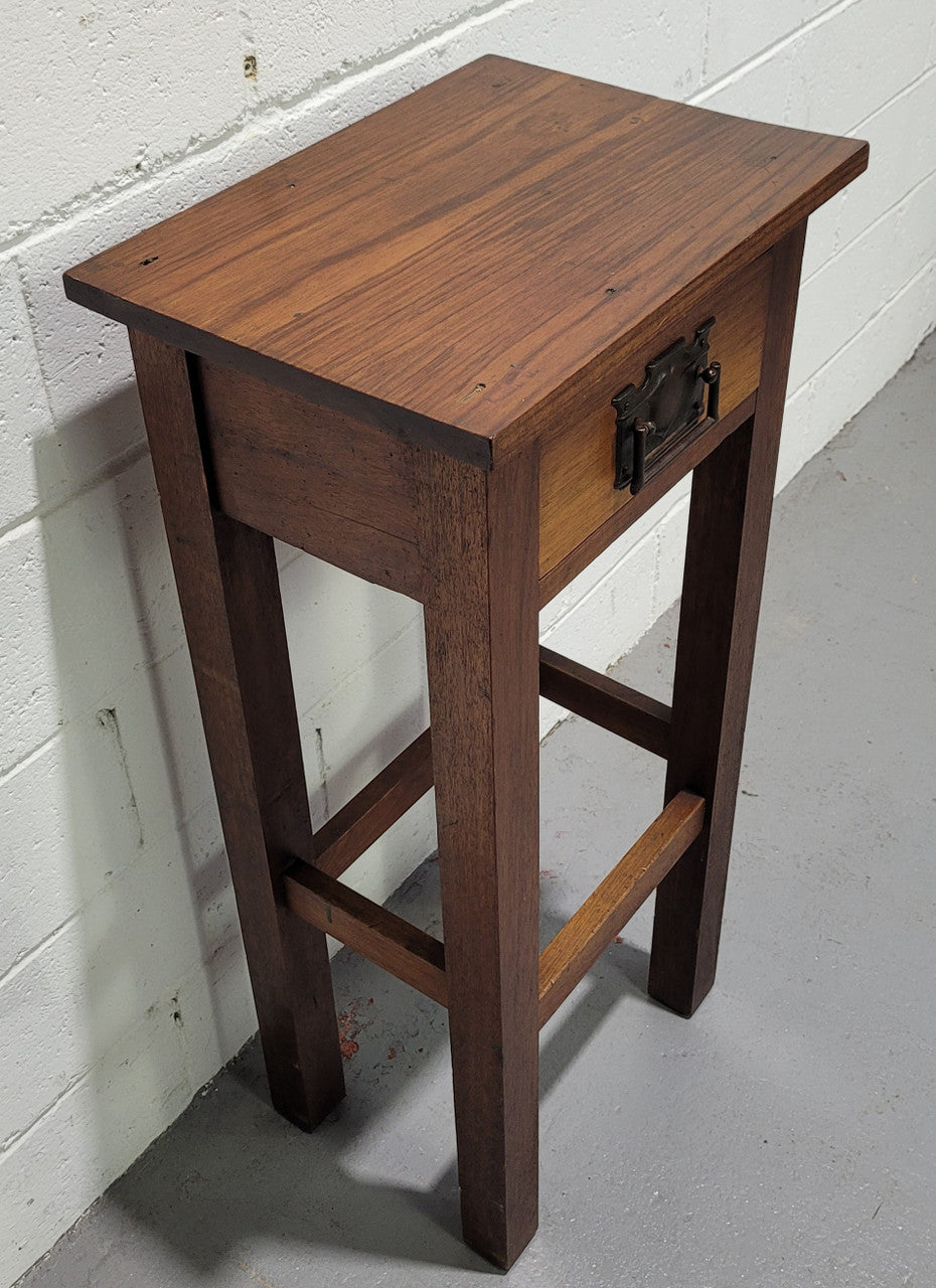 Small Arts and Crafts side table/bedside table. With drawer and is in good original detailed condition.