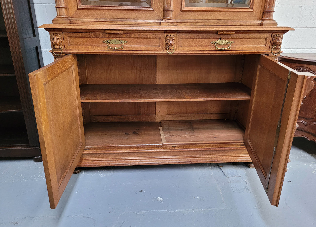 Amazing French 19th Century Oak two-door bookcase. Amazing detailed carvings throughout and plenty of storage space with three adjustable shelves at the top, two drawers, and a further shelf at the bottom. Also has two pull out reading slides giving you a large area to view your books on. In very good original detailed condition.