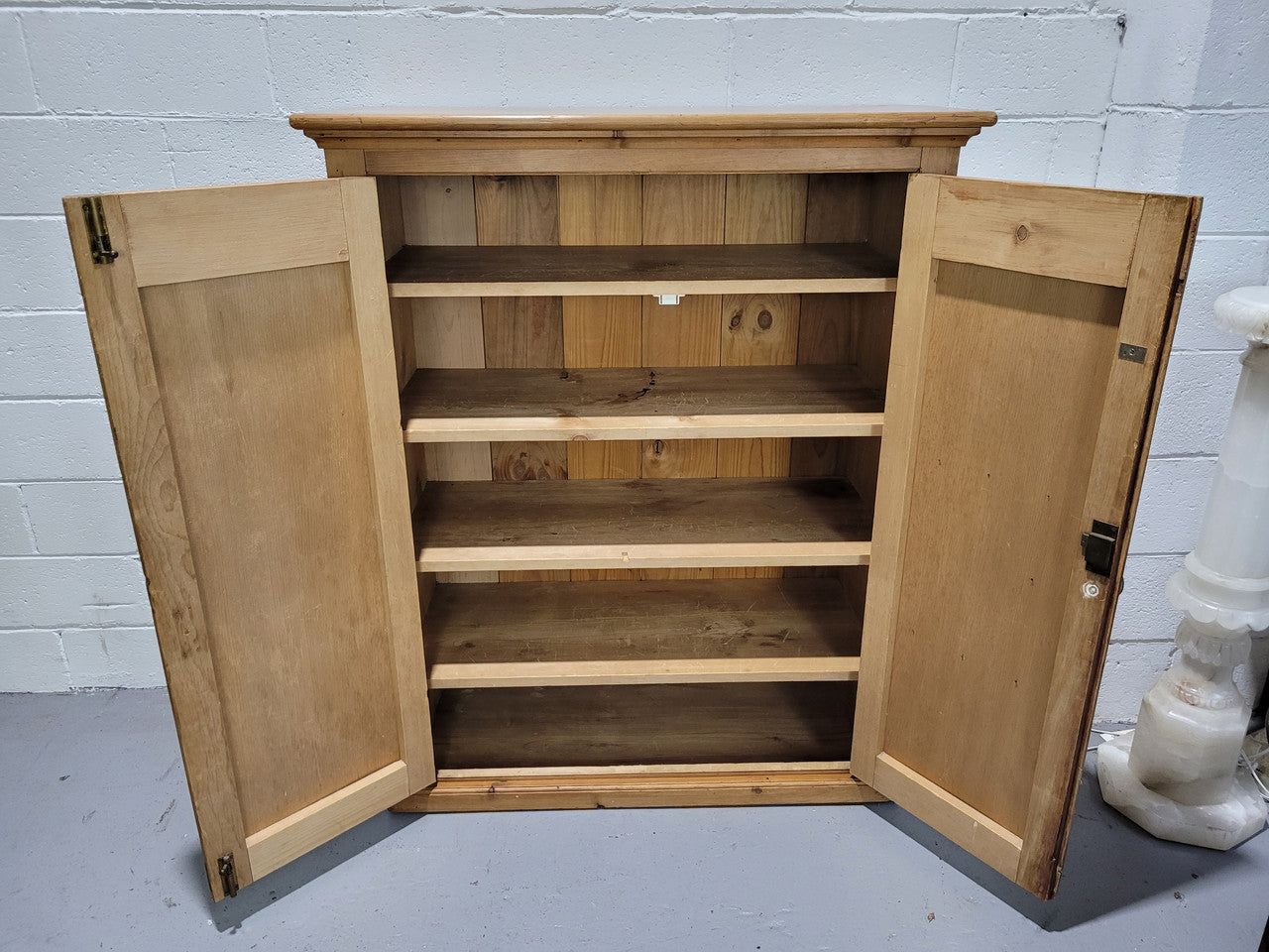 A lovely Victorian Pine shield cupboard with two doors and four shelves in good original detailed condition.