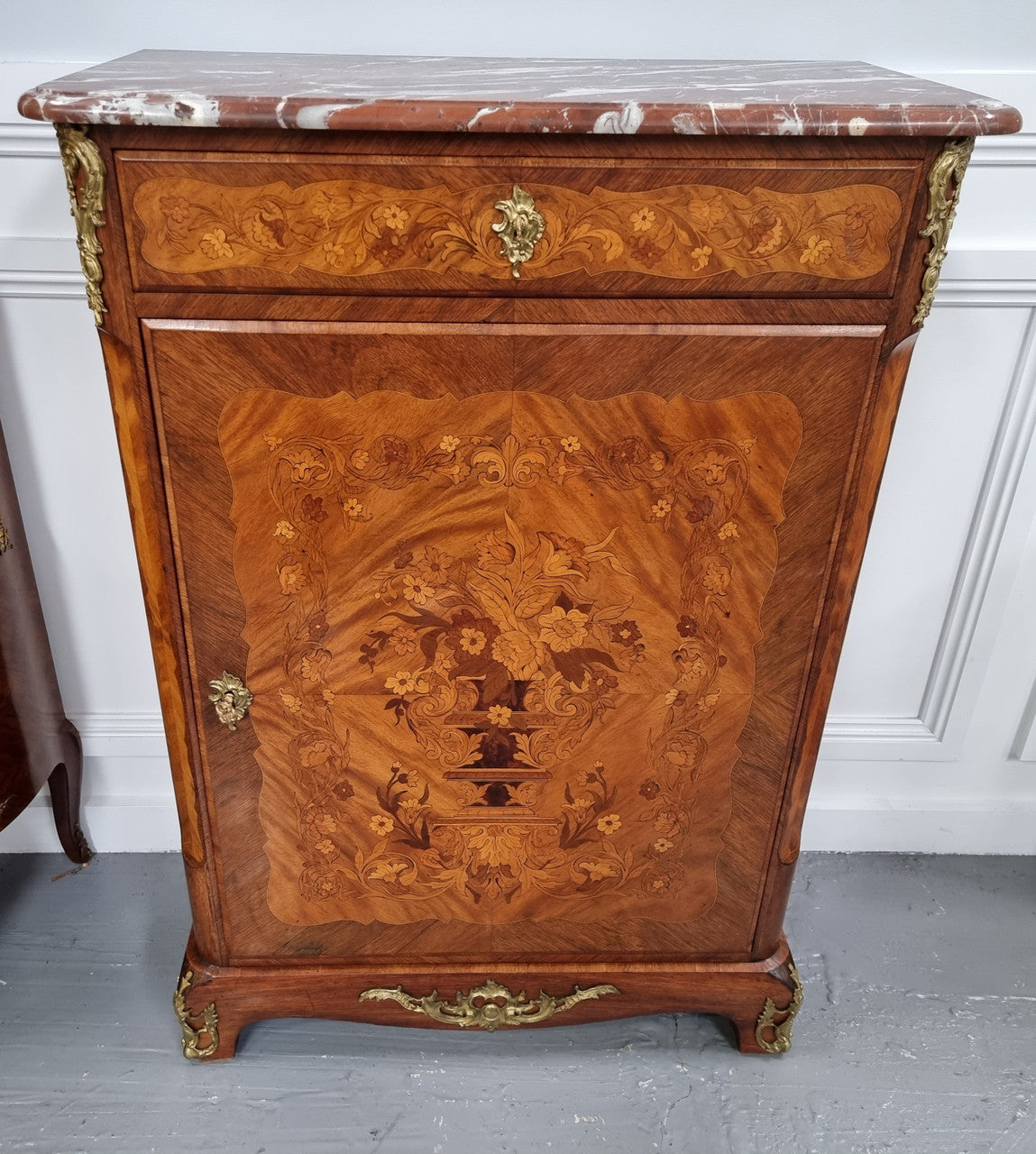 Elegant French transitional style Walnut & Kingwood Salon cabinet. It has beautiful marquetry inlay, a marble top and decorative ormolu mounts. Sourced From France and is in good original detailed condition.
