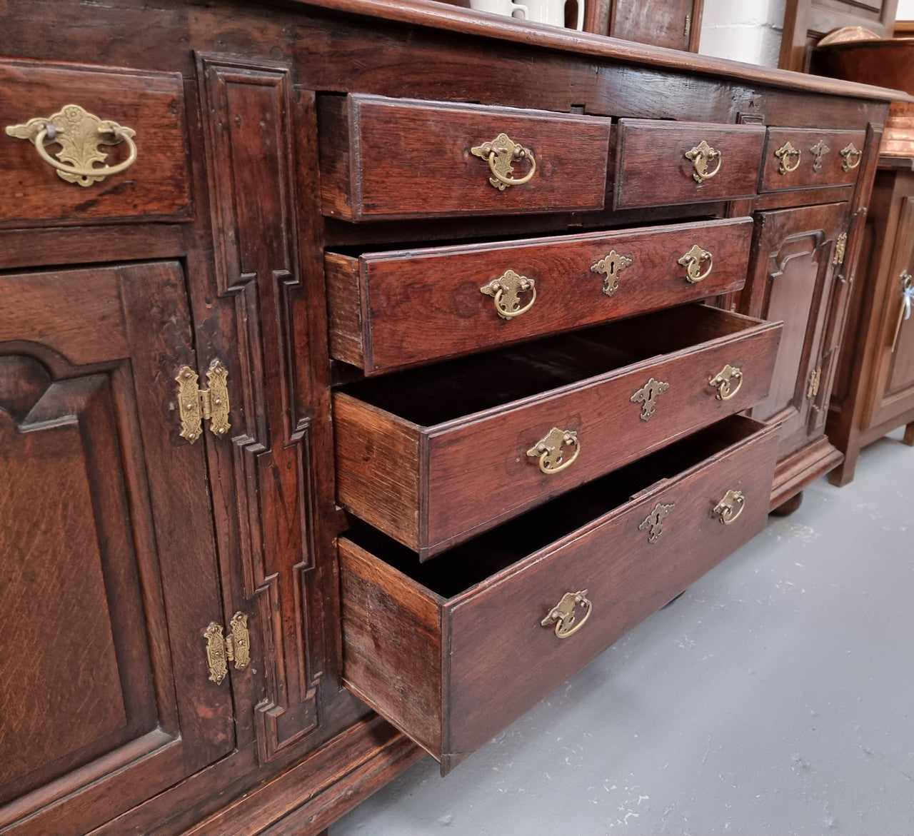 18th Century English Oak Farmhouse dresser of grand proportions. It was sourced in France and not only looks amazing but also has plenty of practical storage space. It is in good original detailed condition.