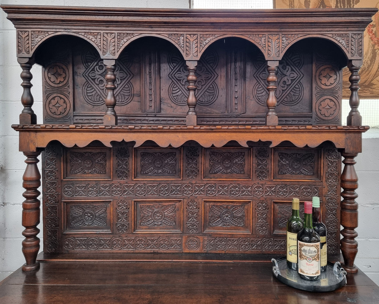 Impressively carved 18th Century English Oak kitchen dresser in 17th Century Jacobean style. It is in good original detailed condition and has been sourced from France.