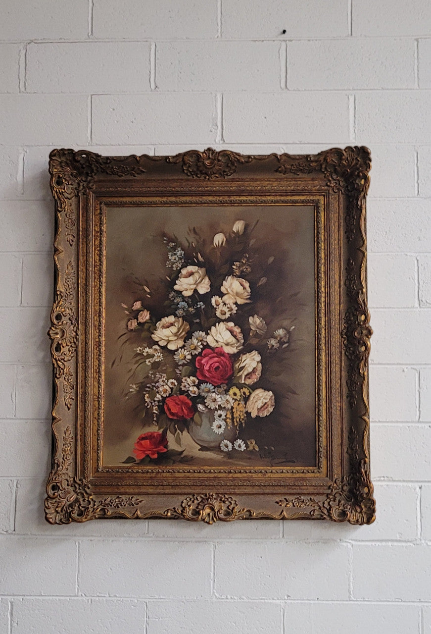 Attractive French floral oil on canvas - signed. Mounted in a stunning patterned gilded frame. It is in good original detailed condition.