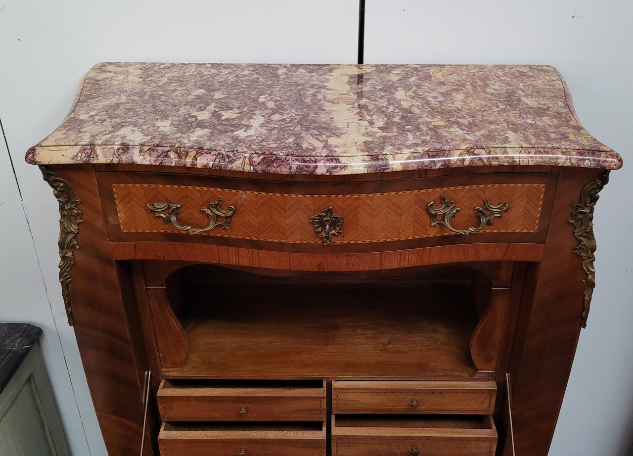 Walnut Louis XV style marble top abbattant with beautiful parquetry inlay and ormolu mounts. It has plenty of storage space with four large drawers and four smaller internal drawers. Beautiful drop down desk with a leather insert. In very good original detailed condition.