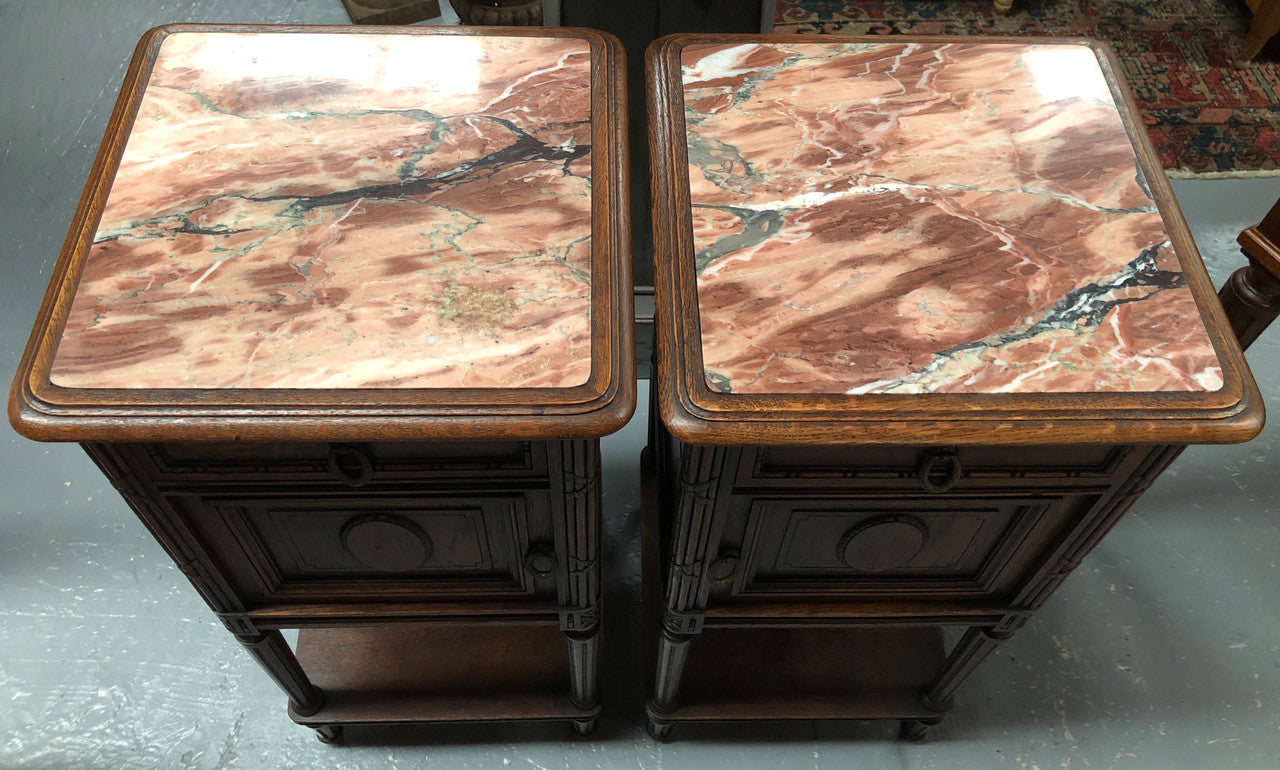 Lovely pair of French Oak Louis XVI style bedside cabinets with inset marble tops a drawer and a cupboard for storage. In good original detailed condition.