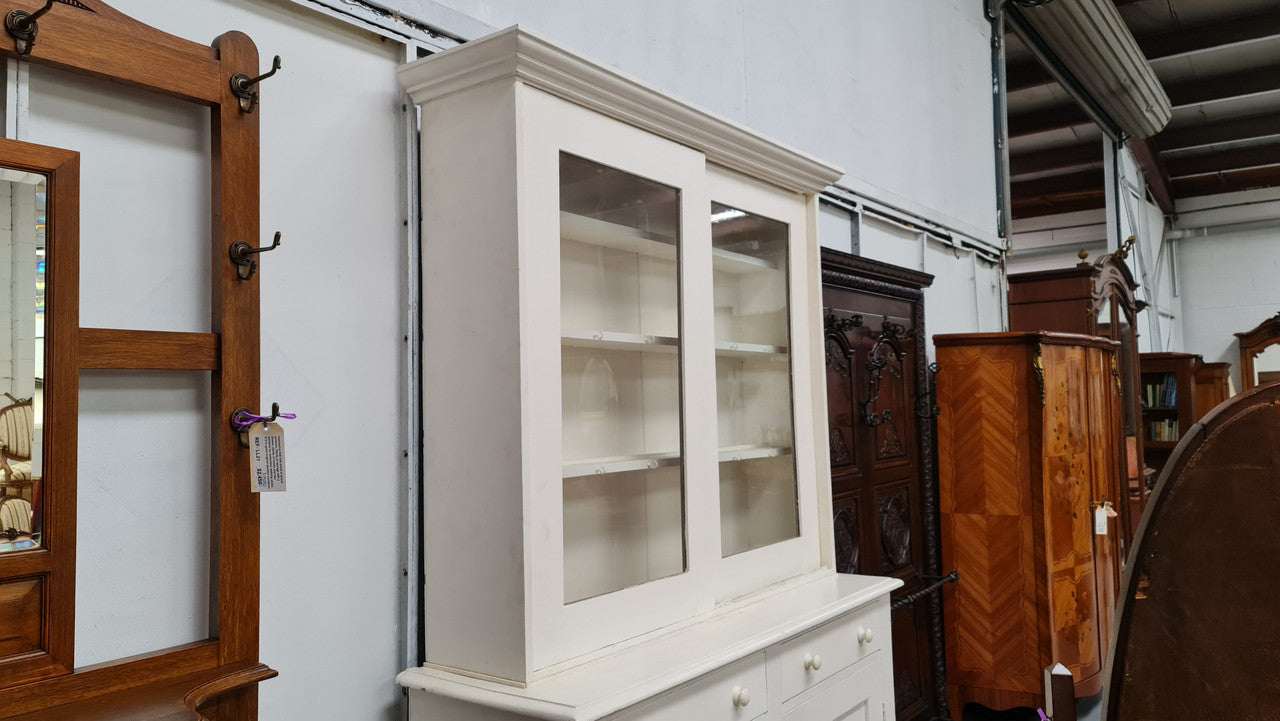 Australian painted two door kitchen hutch display and buffet cabinet. The top section has hooks and shelves. The bottom has two drawers along with cupboard space for added storage. In good original condition.