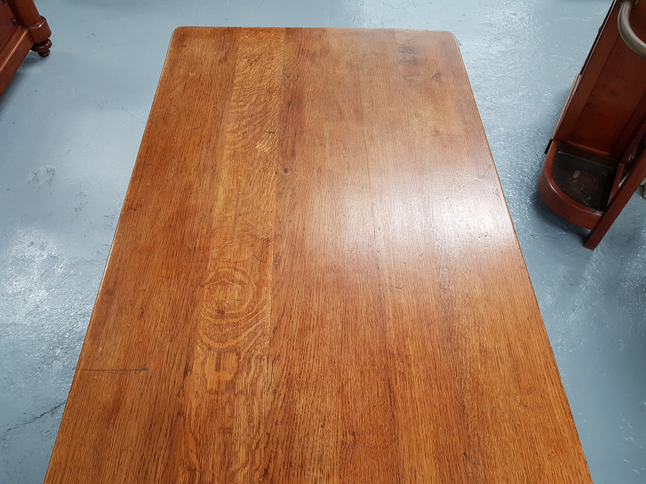 French Oak Spanish style dinner table with beautiful simple iron work underneath. Table top is in good original condition with character marks and has a wax finish. Circa 1930.