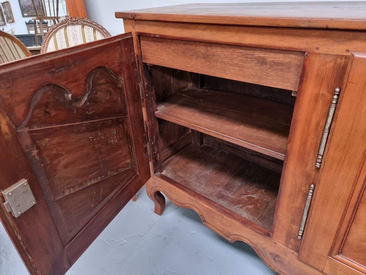 Early 19th Century Louis XV style Fruitwood three door sideboard. It has three hidden internal drawers and one of them has green valet and small sections for cutlery. It is in good restored condition.