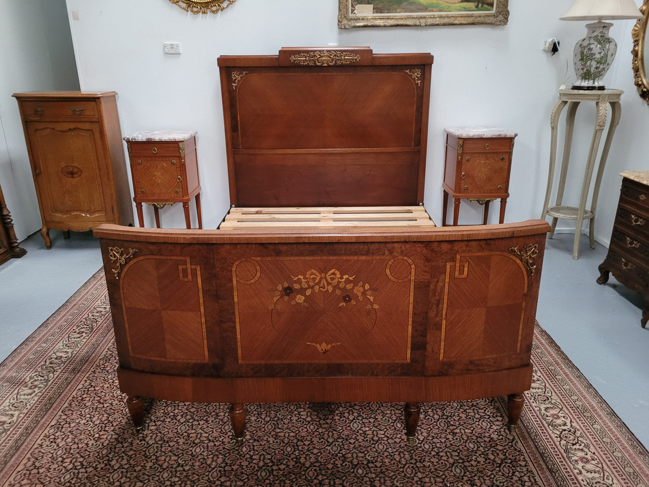 A high quality French Louis XV style bow fronted Queen size bed with marquetry inlay and ormolu mounts. In good original detailed condition. Circa: 1920