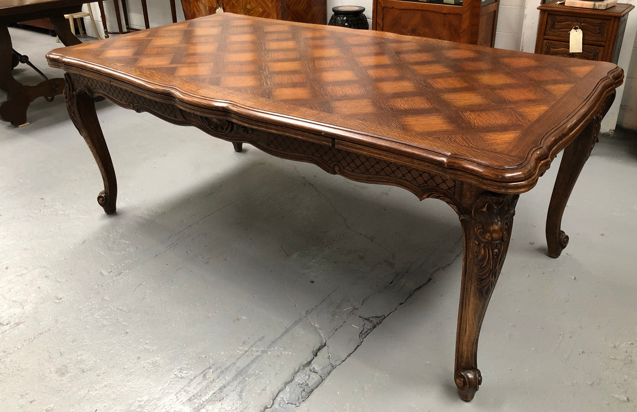 High quality French Oak Louis XV Style, beautifully carved extension table. It has an amazing parquetry top and when fully extended measures to 3 meters long. In very good original detailed condition.