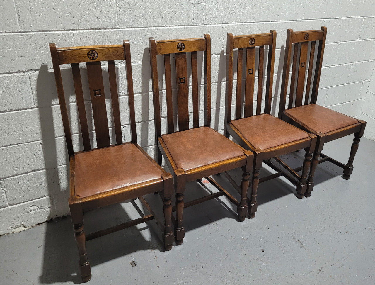 Fabulous small Oak extension table and four dining chairs. The table extends from a four seater to a six seater. The chairs have nice carvings and leather inset seats. They are in original detailed condition.