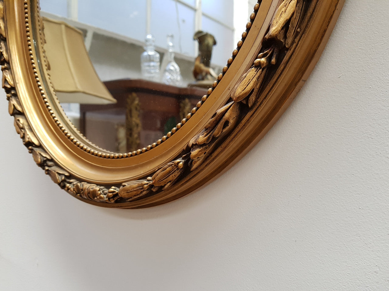 Antique French Gilt Oval Shape Mirror With Ribbon Crest