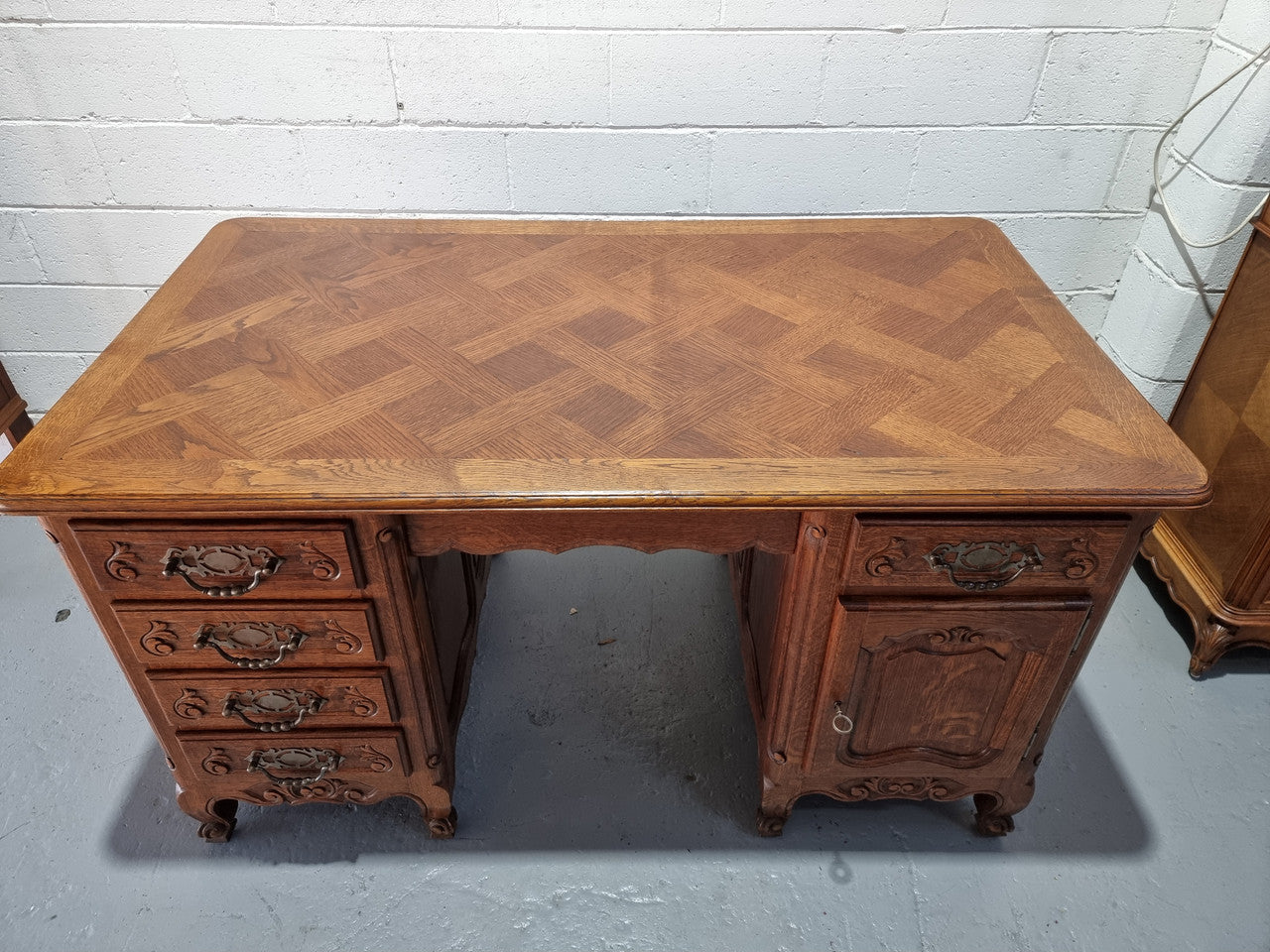 Beautifully carved french oak, faux partners desk with a lovely parquetry top and 6 drawers and 1 cupboard . In good original condition.
