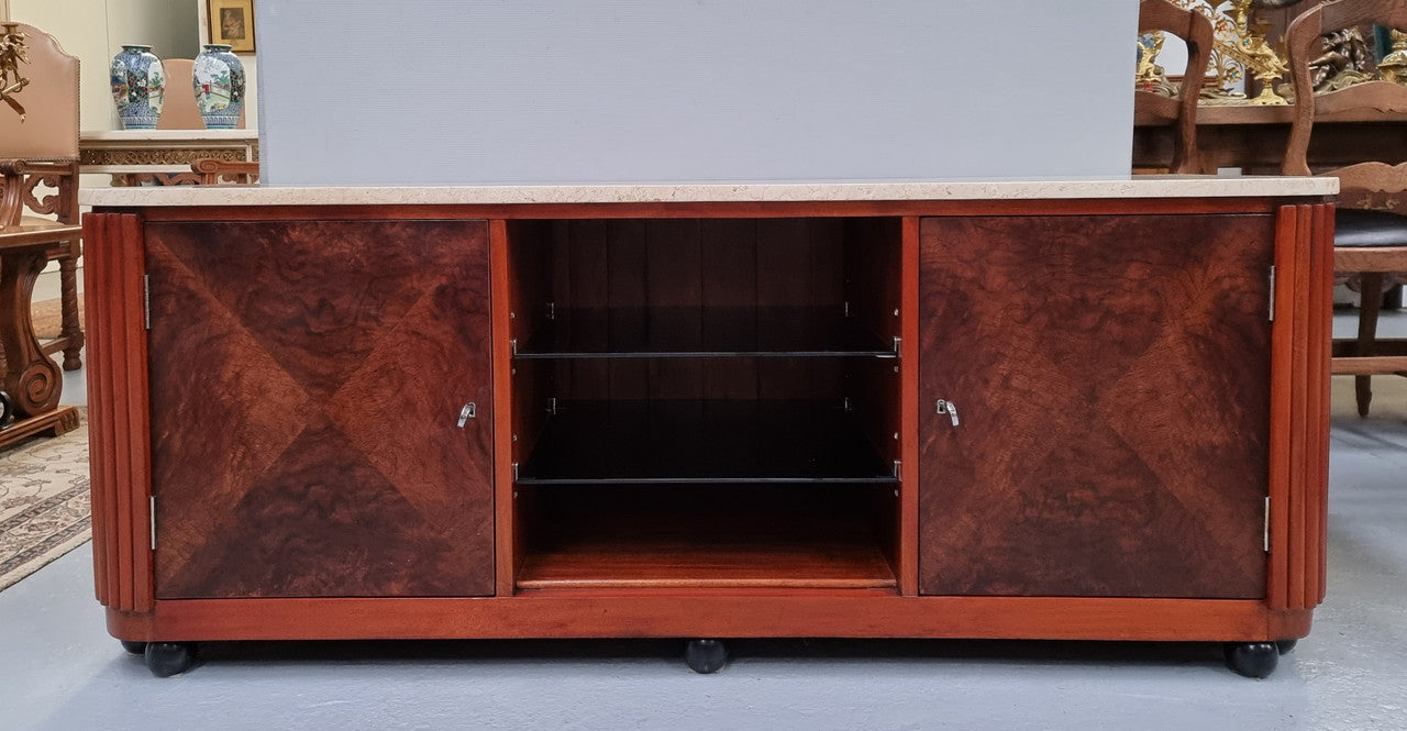 Beautiful Bespoke Art Deco style walnut and mahogany low line cabinet with a marble top and plenty of storage. It has two doors with a shelf each side and in the middle in has two glass shelves. Would make an ideal TV cabinet and has a hole in the back to run cords through. In very good original detailed condition.