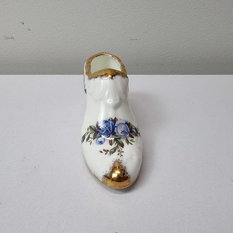 A lovely pair of Royal Albert China shoes in good original condition. Stamped on the sole 'Moonlight Rose: Royal Albert Bone China, England ©1987.