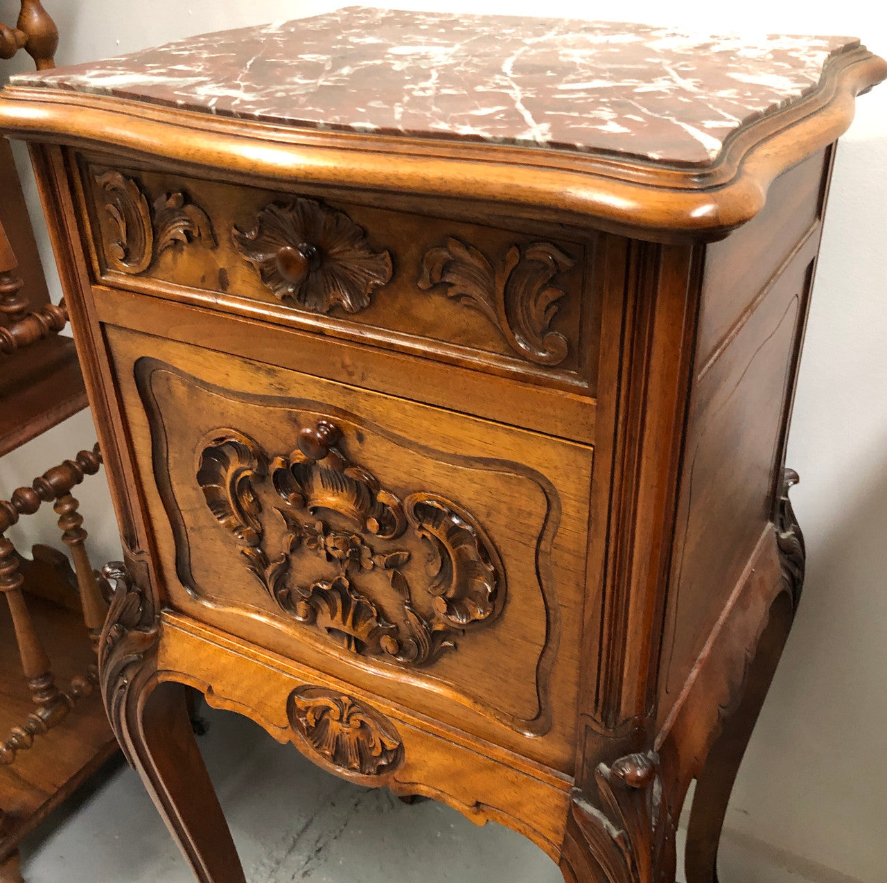 Single French carved bedside with inset marble top. It has beautiful carving and a drawer and cupboard for storage. In very good original detailed condition.