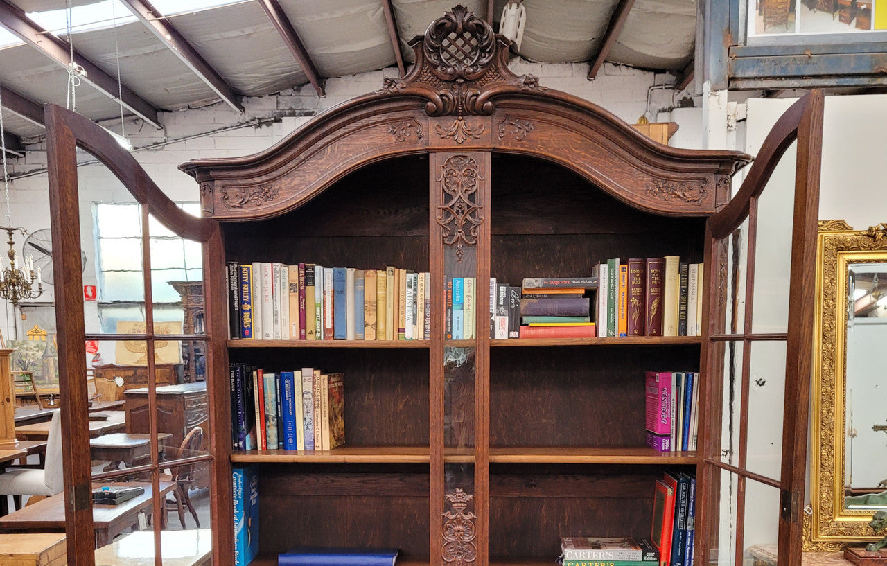 Substantial French Oak Louis 15th Style large two door bookcase. Adjustable shelves and very decorative carving. In good original detailed condition.