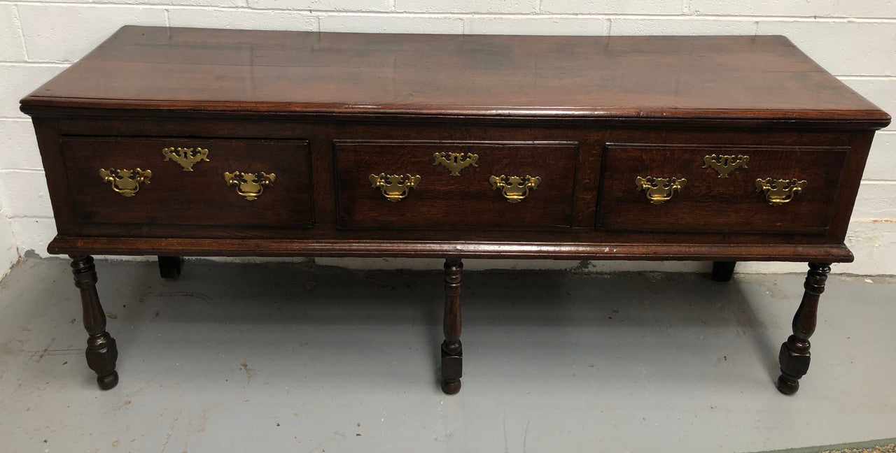 Early 19th Century English Oak dresser base with three large drawers. In very good original detailed condition.
