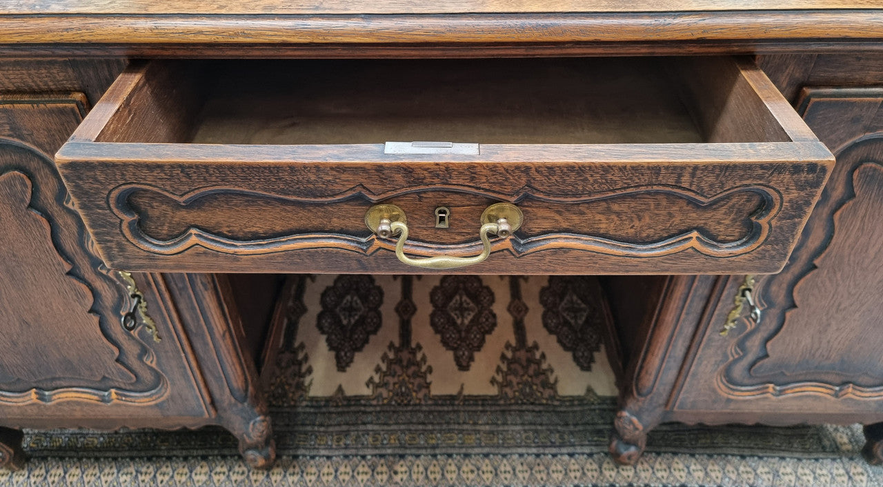 Fabulous Louis XV style French Oak beautifully carved full partners desk. Both sides have a functioning drawer in the middle and two cupboards either side. On both sides one cupboard door opens up to four smaller internal drawers. Plenty of storage space and a large top surface to work on. It is in good original detailed condition.