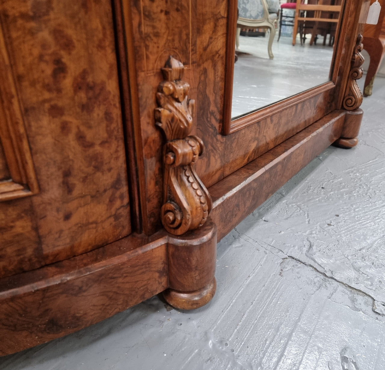 An elegant Antique Victorian Burr wood Walnut marble-top sideboard credenza with a mirrored center door. It has a white shaped marble top, mirror front, nicely carved details and three swing doors along with two keys. It is in good original detailed condition.