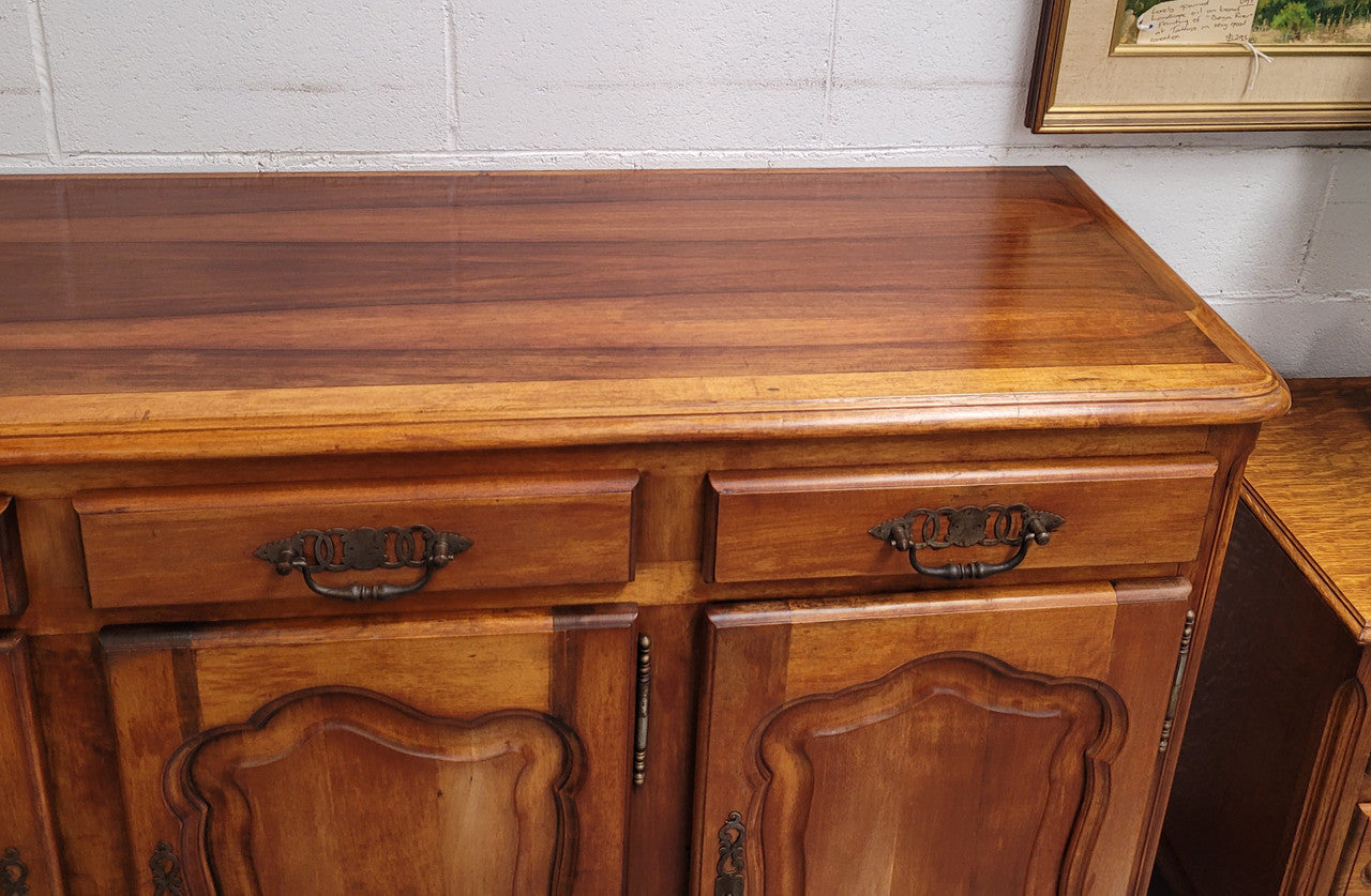 Beautiful French three door three drawer Louis XV style Cherrywood sideboard. It has a total of four adjustable shelves and comes with three keys. It has been sourced from France and is in good original detailed condition.