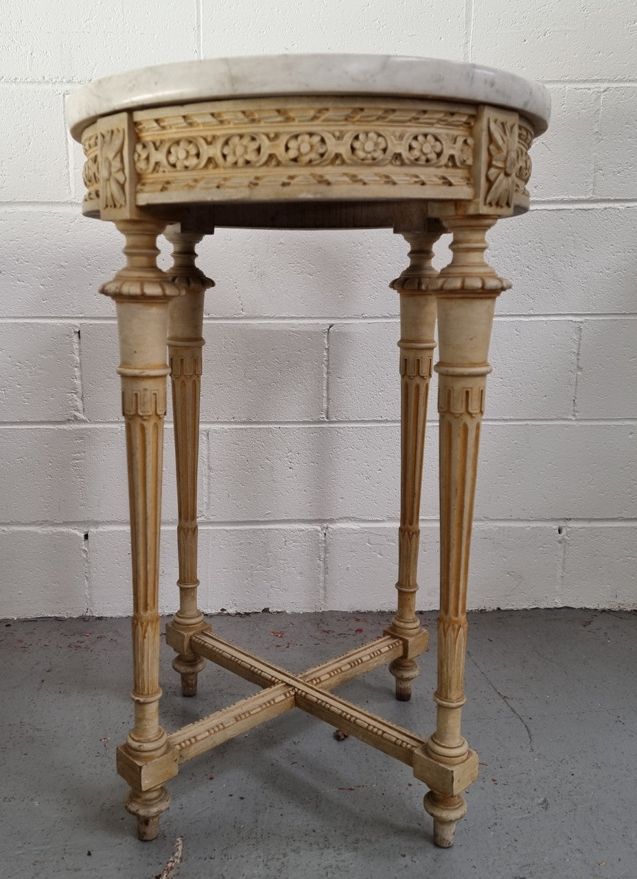 Louis XVI style round side table with original paint and a beautiful thick marble top. It is in good original detailed condition.