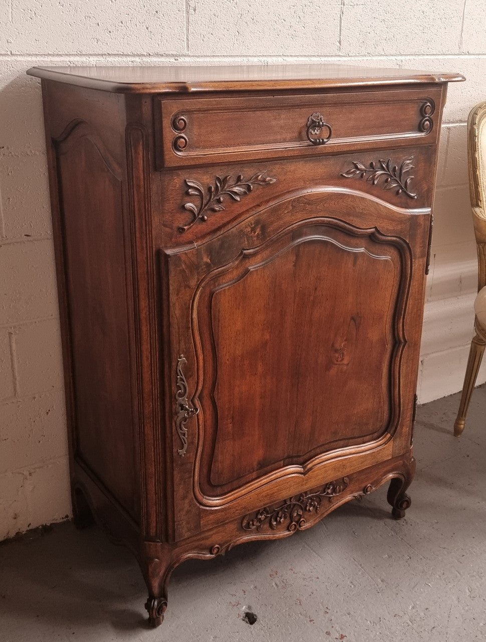 Louis 15th style walnut cupboard consisting of one drawer and two shelves. A pleasing unit with charming carvings. Circa: 1920's. In good original detailed condition.