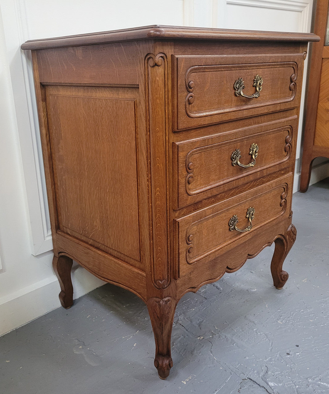 French Oak Louis XV style side drawers with lovely handles and three drawers. It has been sourced from France and is in good original detailed condition.