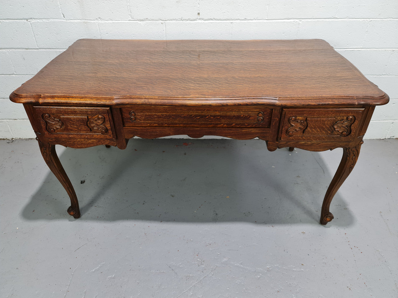 Attractive large Louis XV style Oak faux partners desk. Nicely carved details with three large functioning drawers, and three faux drawers at the back. In good original detailed condition.