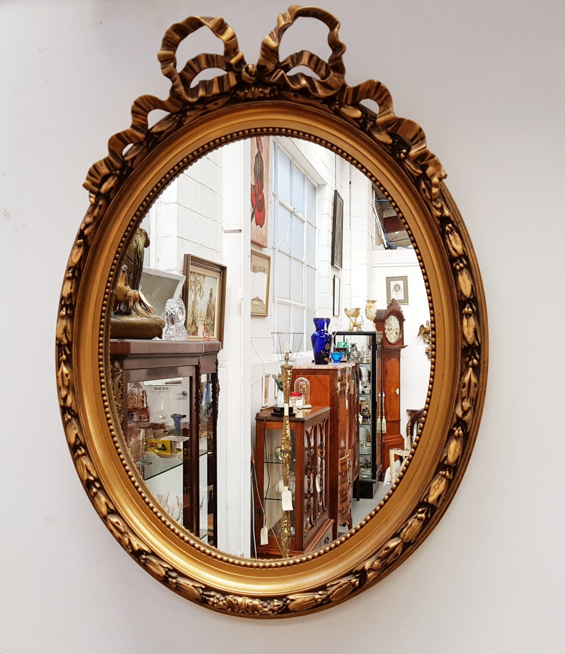 Antique French Gilt Oval Shape Mirror With Ribbon Crest