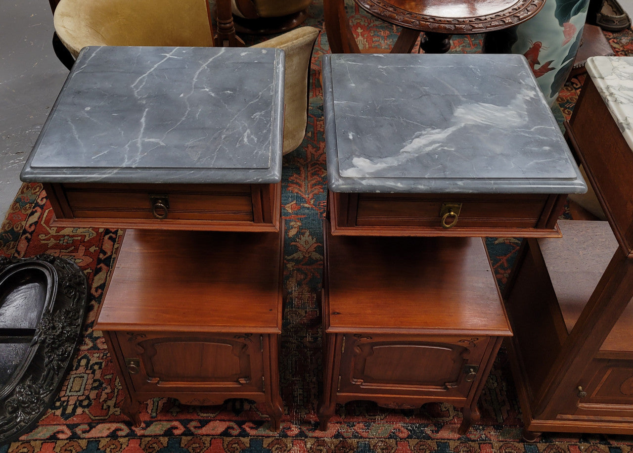 Pair of unusual transitional fruit wood marble top bedside cabinets. They have been sourced from France and are in good original detailed condition.