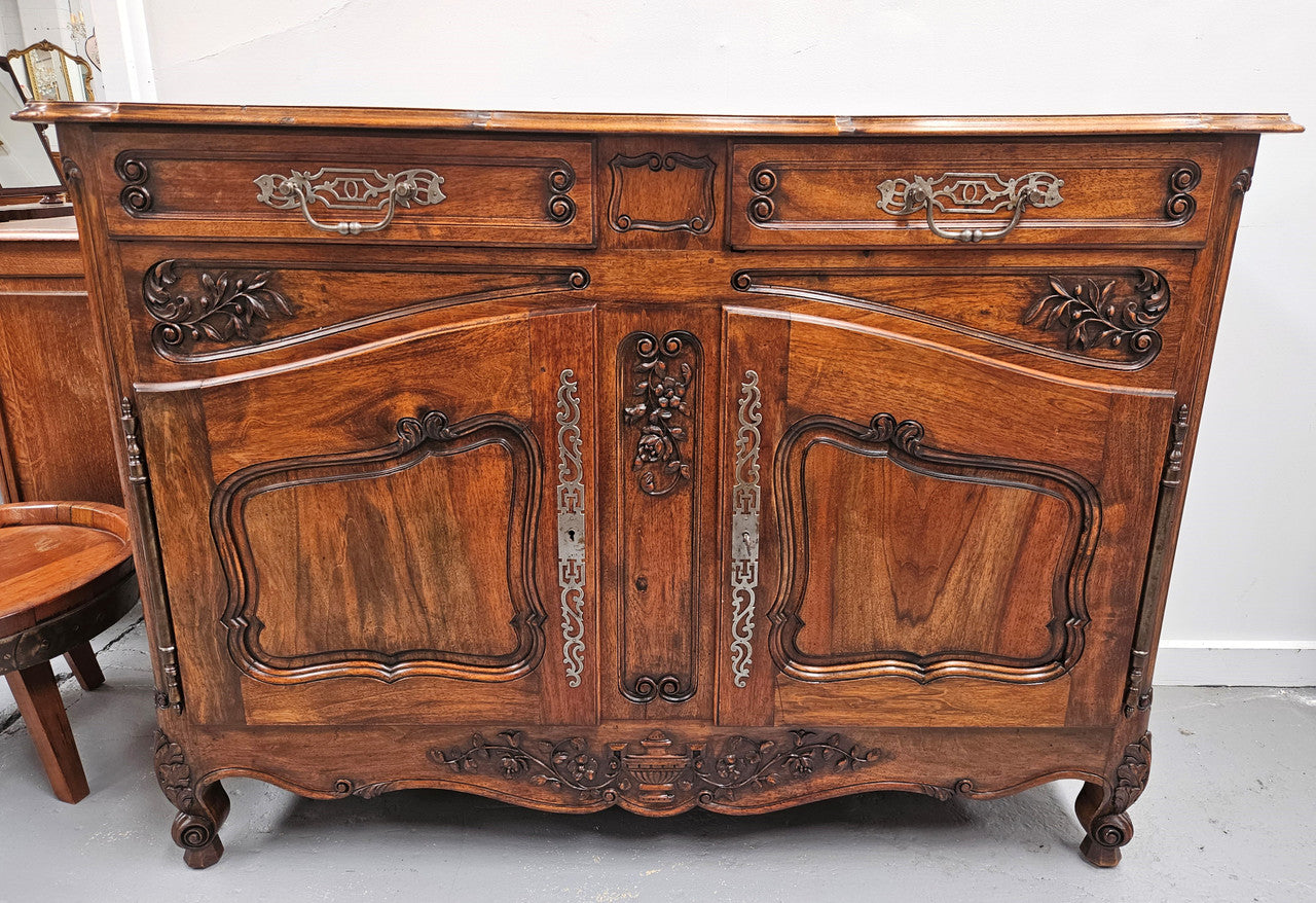 Attractive French Walnut Louis XV style two door two drawer sideboard featuring beautiful carving. Circa: 1930's. It has been sourced from France and it is in good original detailed condition.