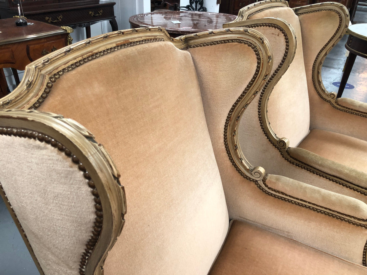 Pair of Vintage French original painted bergere wingback armchairs. The fabric is in very good original condition, please view photos as they help form part of the description. Please note the matching foot stool is being sold separately.