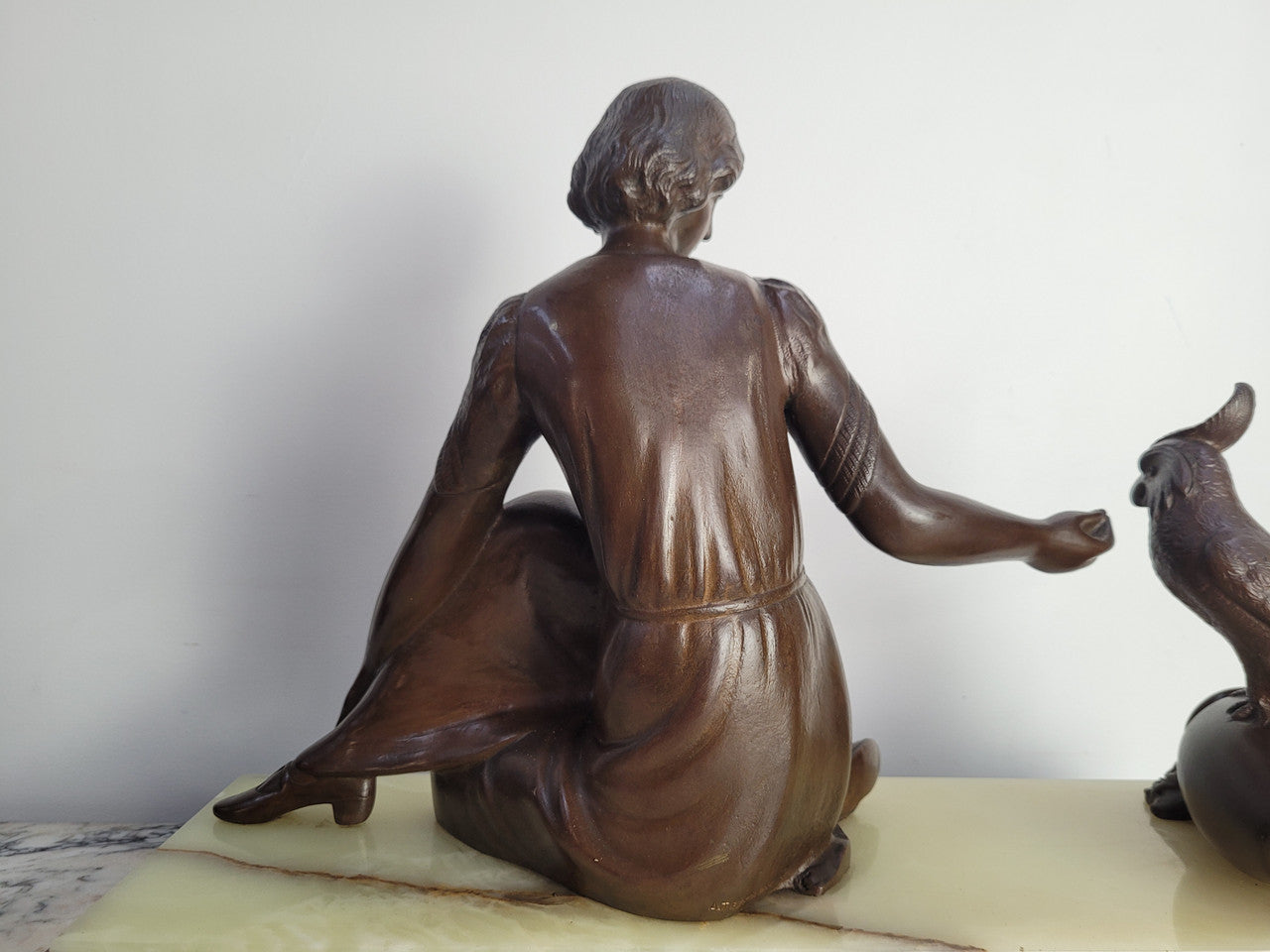 Art Deco bronze statue with brown patina of a lady and parrot on marble base. Signed by Italian Sculptor A Trefolini, an highly regarded sculptor, in very good condition.