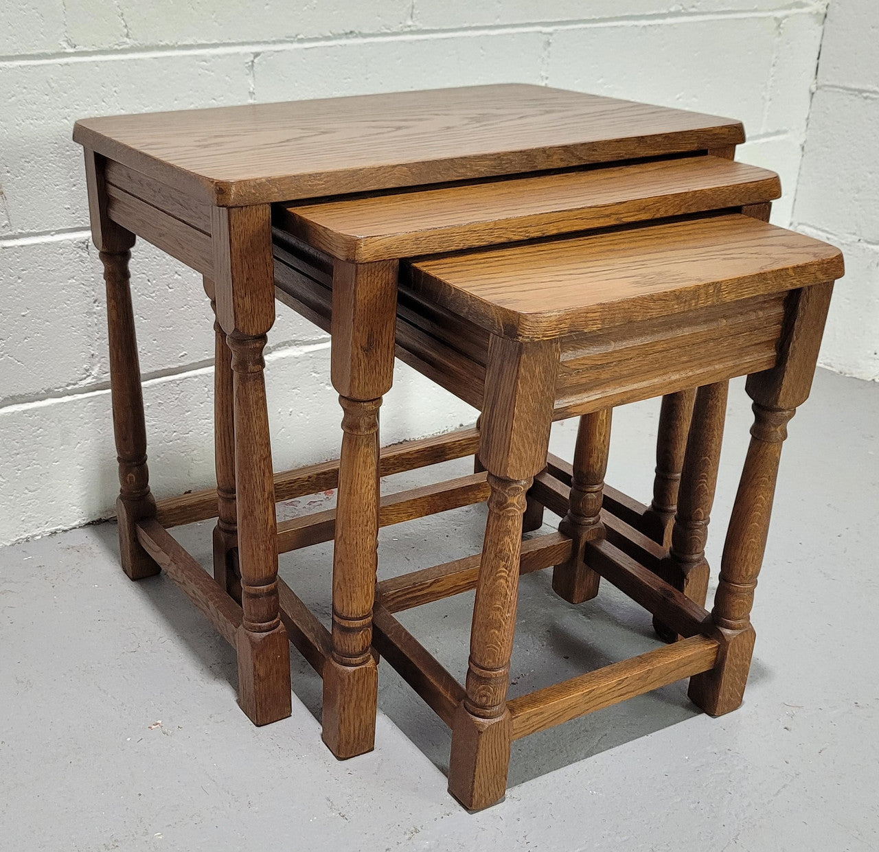 Lovely tudor oak style three nest tables. Circa 1950, In good original detailed condition.