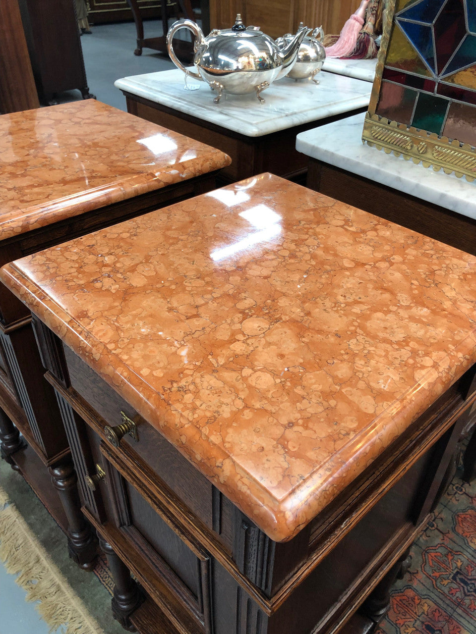 A matched pair of French oak marble topped bedsides. Comprising one drawer and one cupboard.