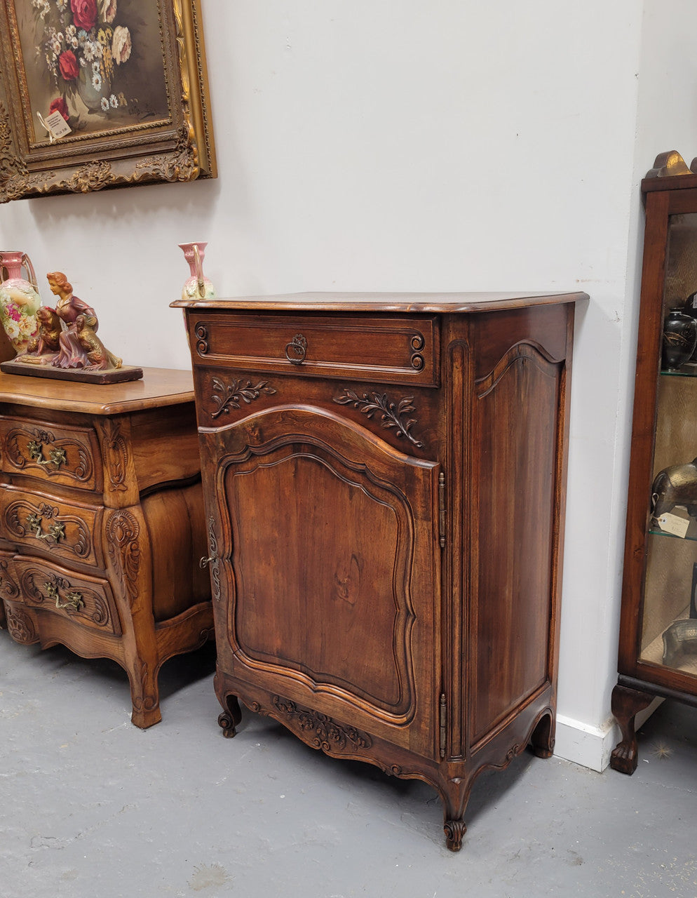 Louis 15th style walnut cupboard consisting of one drawer and two shelves. A pleasing unit with charming carvings. Circa: 1920's. In good original detailed condition.