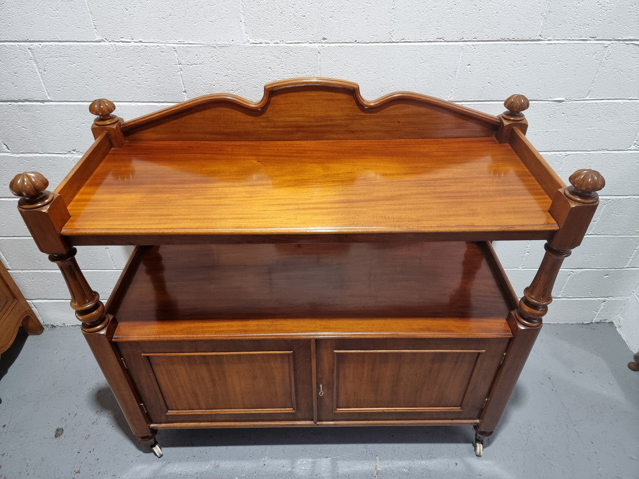 Victorian Mahogany Dumb Waiter with two cupboards, original casters in good detailed condition.