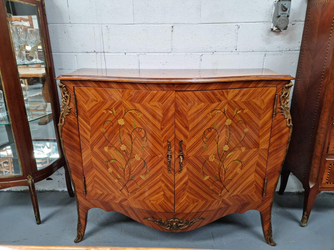 A high quality Louis XV style Kingwood marquetry inlay cabinet. Features extensive inlay inside the doors, and has beautiful ormolu mounts. In good original detailed condition.