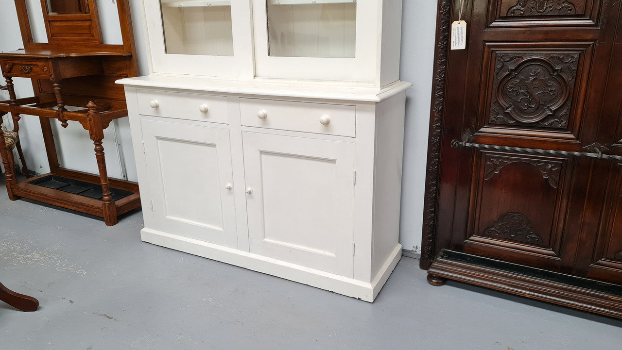 Australian painted two door kitchen hutch display and buffet cabinet. The top section has hooks and shelves. The bottom has two drawers along with cupboard space for added storage. In good original condition.