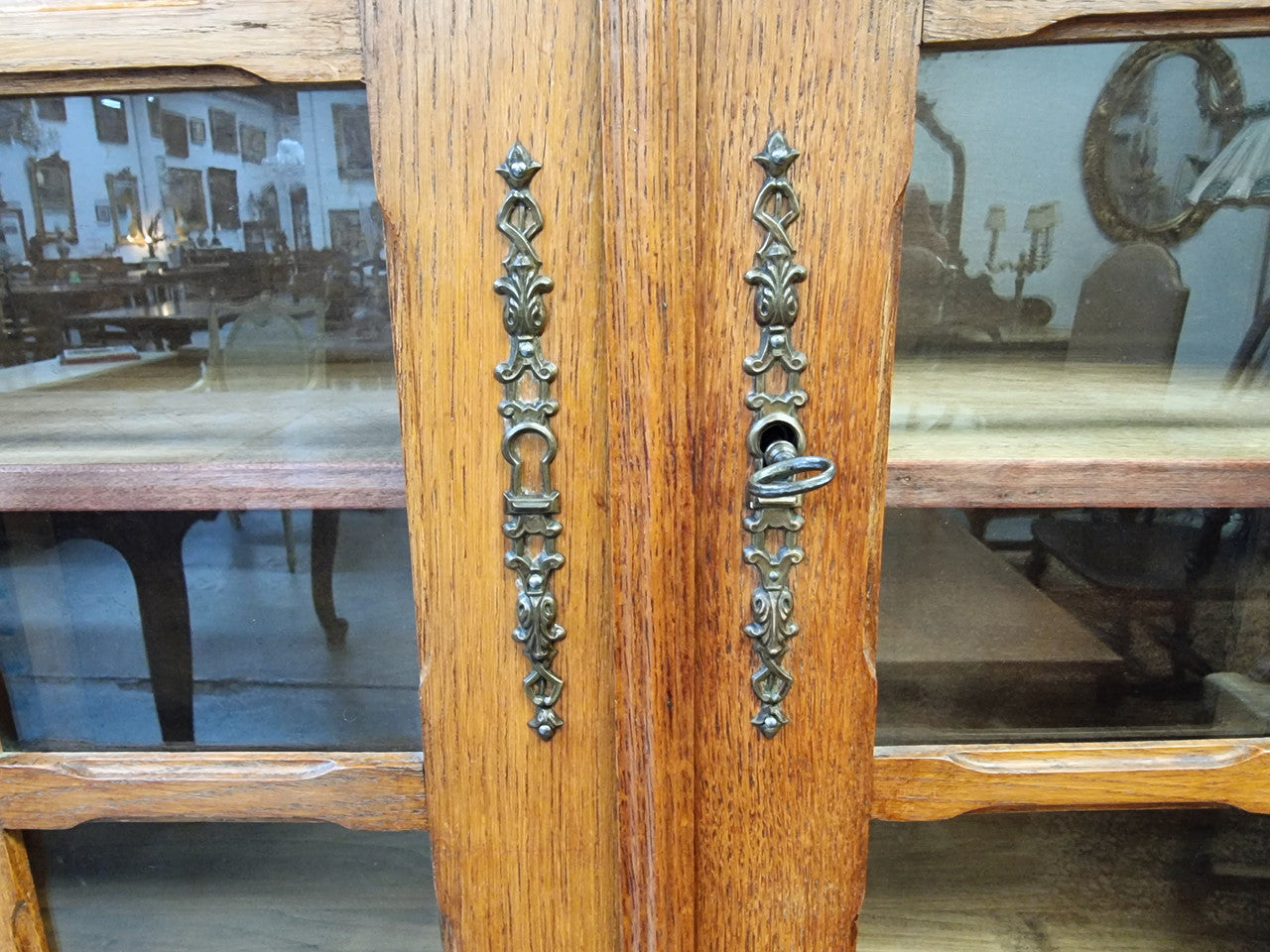 French light Oak two door bookcase with four adjustable shelves. It has beautiful decorative carving and is in good original detailed condition.