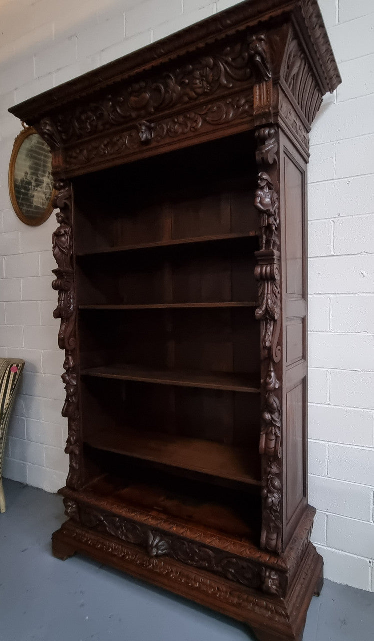 Amazing dark Oak heavily carved Gothic style bookcase with lovely details and adjustable shelves in good original detailed condition. The doors currently have no glass which can easily be added or be left with open shelves.