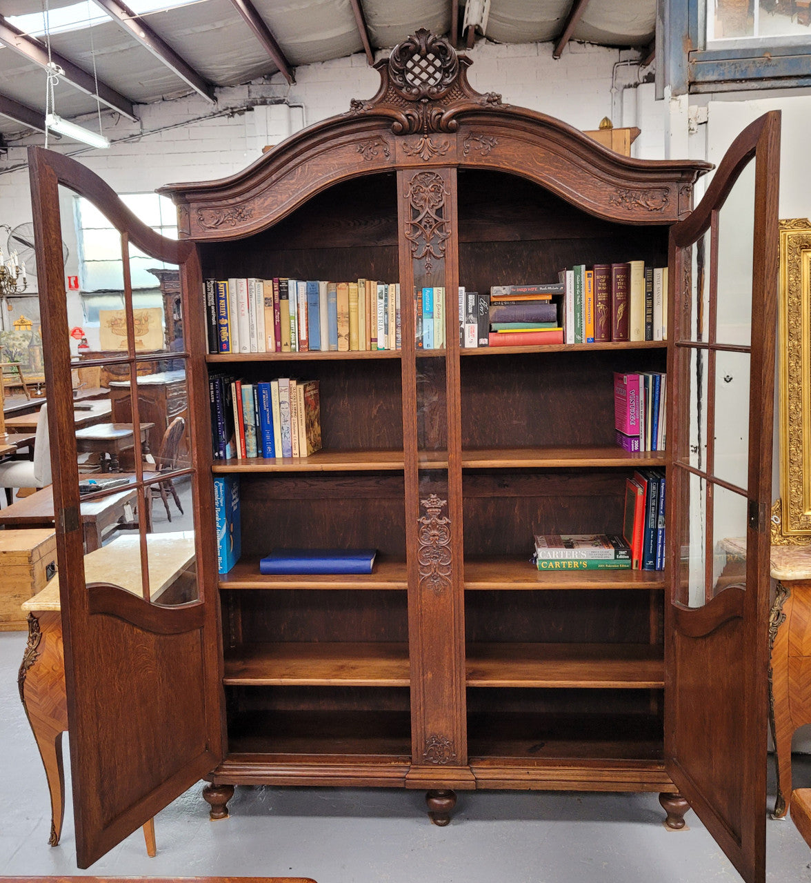 Substantial French Oak Louis 15th Style large two door bookcase. Adjustable shelves and very decorative carving. In good original detailed condition.