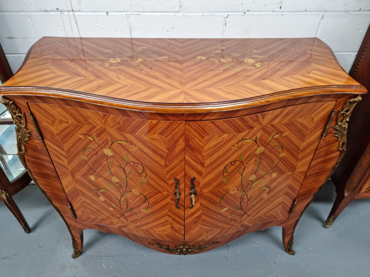 A high quality Louis XV style Kingwood marquetry inlay cabinet. Features extensive inlay inside the doors, and has beautiful ormolu mounts. In good original detailed condition.