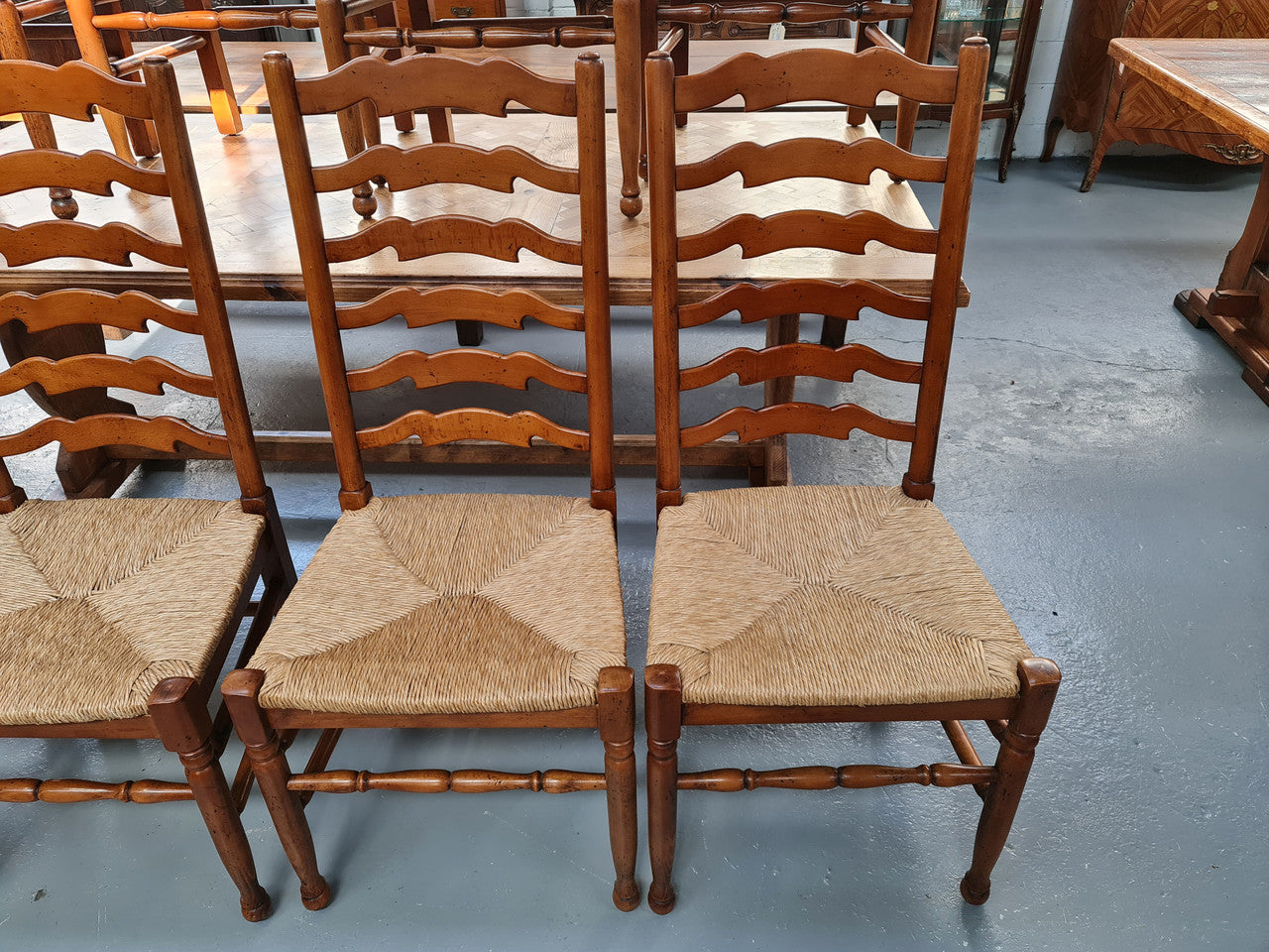Charming set of eight Cherry Wood ladder back dining chairs. They are in good original detailed condition.