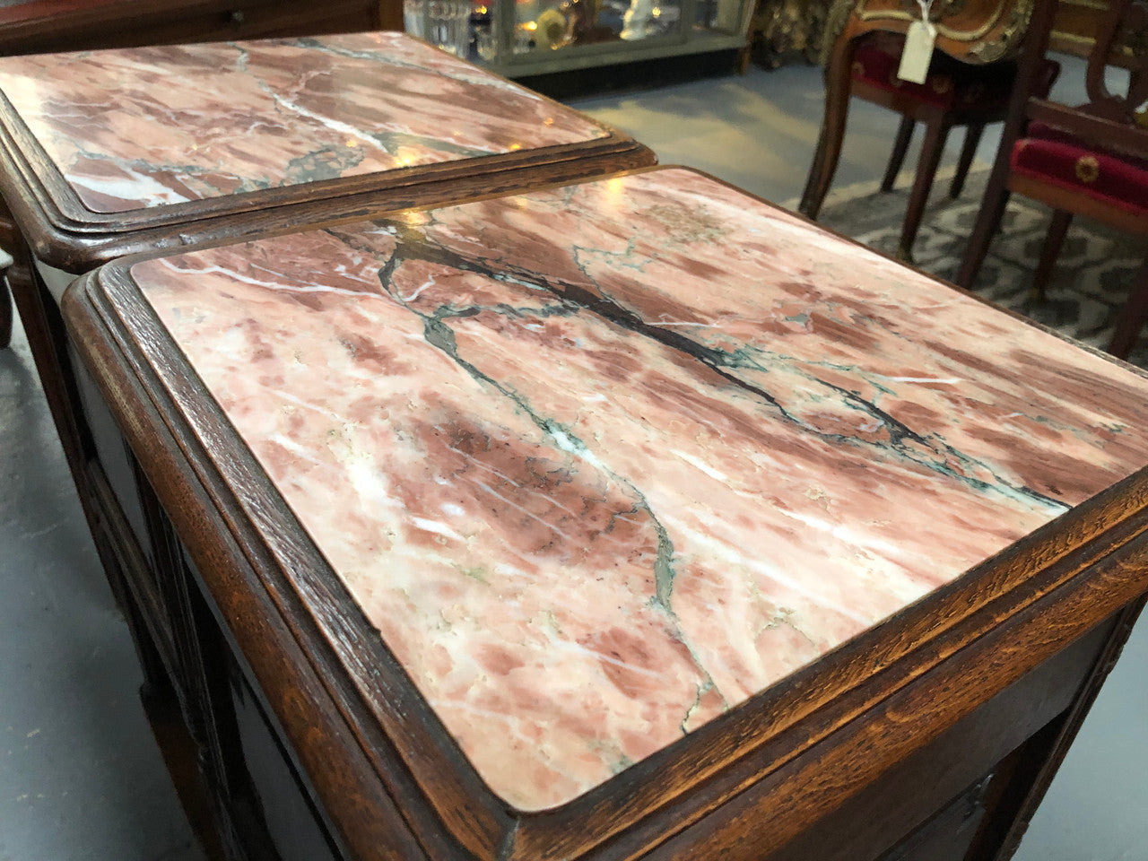 Lovely pair of French Oak Louis XVI style bedside cabinets with inset marble tops a drawer and a cupboard for storage. In good original detailed condition.
