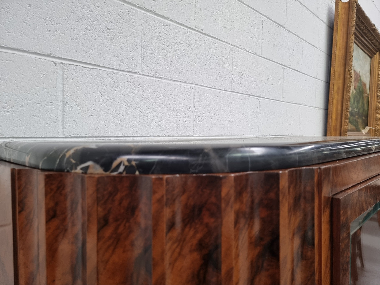 Stunning French Art Deco figured Walnut with Portoro marble top cocktail cabinet. Features chrome trim on base and glass display in door. It is in fully restored condition.
