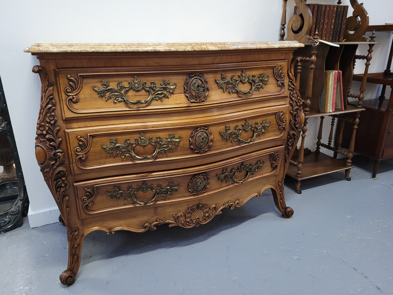 Impressive Louis XV style three drawer walnut commode. Ormolu handles and bevelled marble top complimenting detailed carving. In very good original detailed condition.