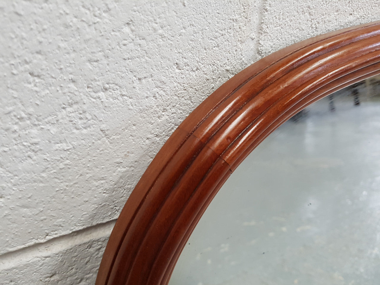 Art Deco mahogany mirror of long and narrow portions. In good original condition and retaining it's original mirror.